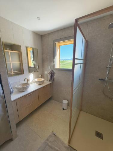 a bathroom with two sinks and a shower at Le Chalet du Soleil Levant in Longevilles-Mont-dʼOr
