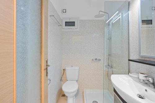 a bathroom with a toilet and a sink at Villa Helia in Yénion