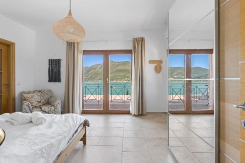 a bedroom with a bed and a view of the ocean at Villa Helia in Yénion