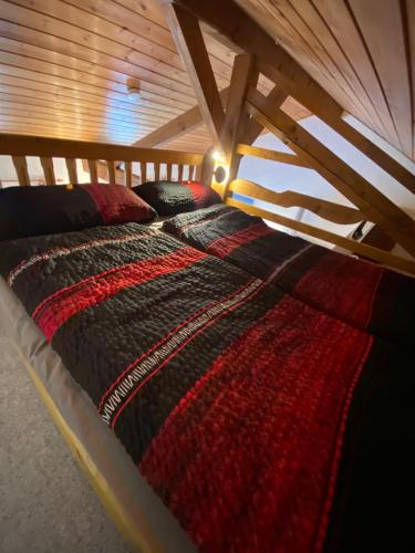 a bed in a room with a wooden ceiling at Ferienwohnung Pickert in Bad Endorf