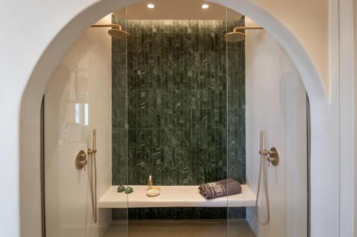 a bathroom with a sink and a shower at Pnoé Lounge Suite in Mandrakia