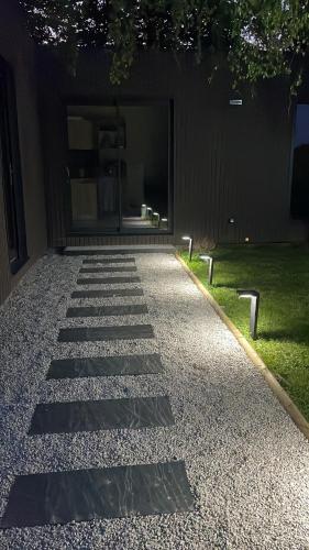 a walkway in front of a building at L'Escale d'Omaha - Cottage de 50m2 in Saint-Marcouf