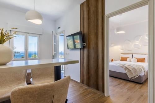 a bedroom with a bed and a table and chairs at Kastri Houses in Panormos Skopelos