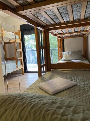 a bedroom with a bunk bed and a ladder at Savannah Pousada in São Paulo