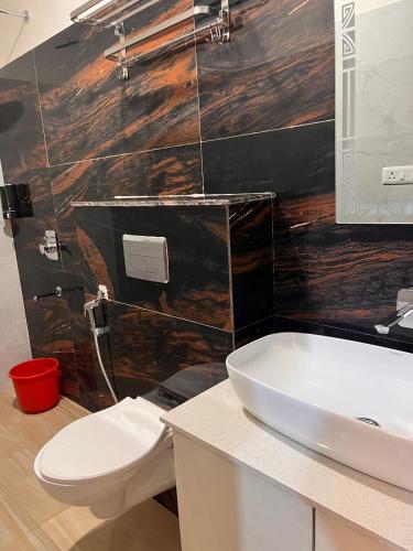 a bathroom with a white toilet and a sink at MorningInn in Prayagraj