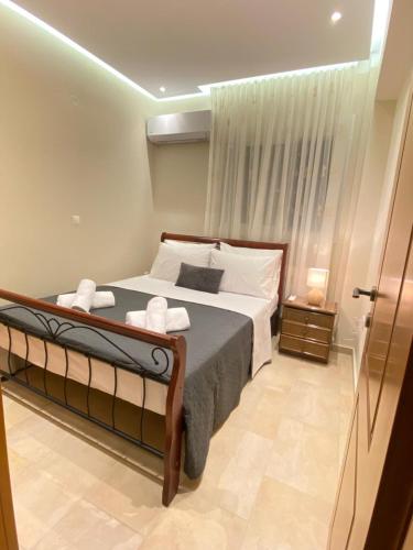 a bedroom with a large bed and a window at Apartment Jorgo Kalithea in Kallithea Halkidikis