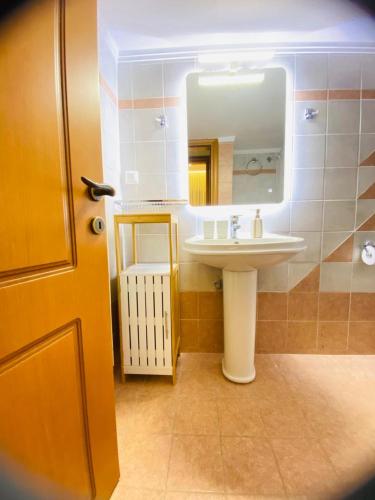 a bathroom with a sink and a mirror at Apartment Jorgo Kalithea in Kallithea Halkidikis