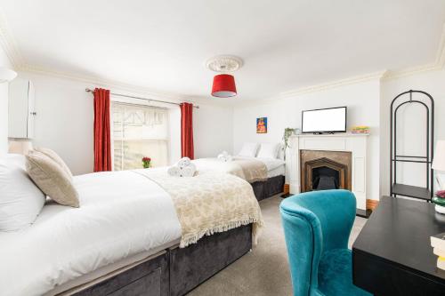 a bedroom with two beds and a fireplace at Central Basement Flat-Parking-By FabAccommodation in Bristol