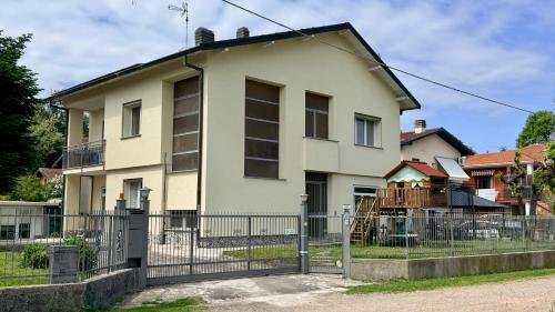 a house with a fence in front of it at Casa Buda 1BR Apartment - Lakes Malpensa MXP 24h Check-in Parking in Sesto Calende