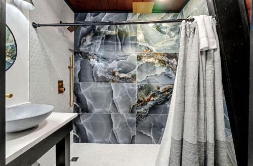 a bathroom with a shower curtain and a sink at Soakin Up The Views in Gatlinburg