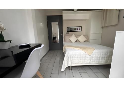 a bedroom with a white bed and a desk at Habitación Tulipán in Oaxaca City