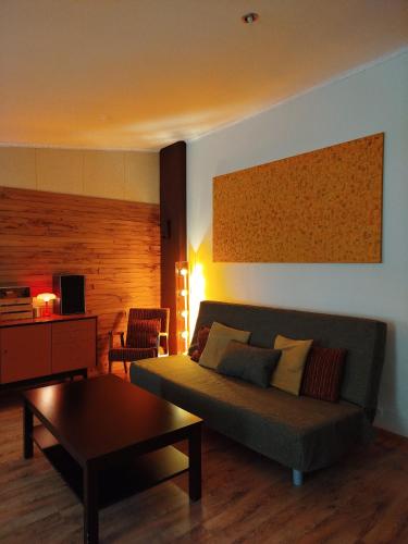 a living room with a couch and a coffee table at Zaļais namiņš in Ventspils