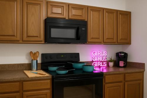 a kitchen with a stove with a neon sign on it at 102 Cecil Cir 3BR2 House in Calera
