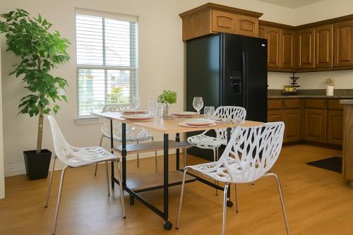a kitchen with a table and chairs and a black refrigerator at 102 Cecil Cir 3BR2 House in Calera