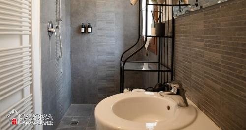 a bathroom with a sink and a toilet in it at Ca' Rossa Lido Venezia in Mestre