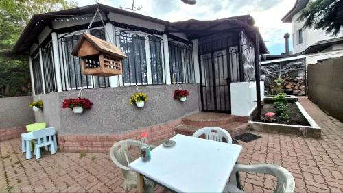 a patio with a white table and chairs and a house at Таки Дача на Фонтане in Odesa