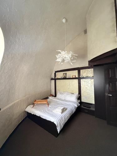 a small bedroom with a bed and a window at Kupol for rest in Irpin