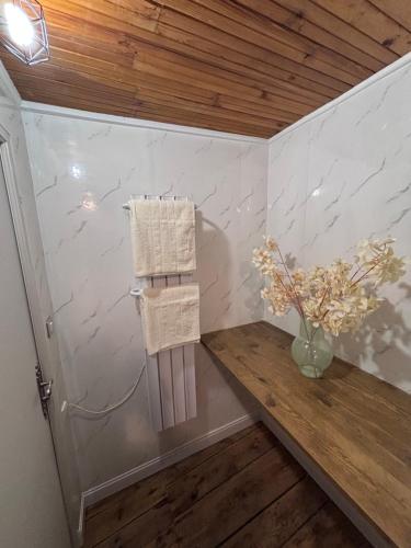 a room with a table and towels on a wall at Comme à La Maison in Cayres