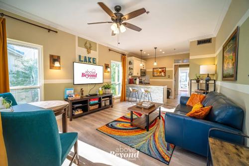 a living room with a blue couch and a table at Sunset & Lakeview from Castle Turret on The Island in Lago Vista