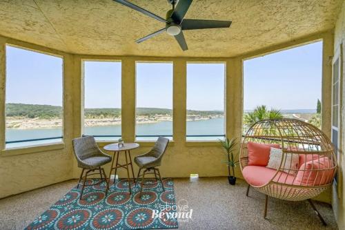 a screened in porch with chairs and a table at Pets Stay Free, Breezy, Stylish Island Elegance in Lago Vista