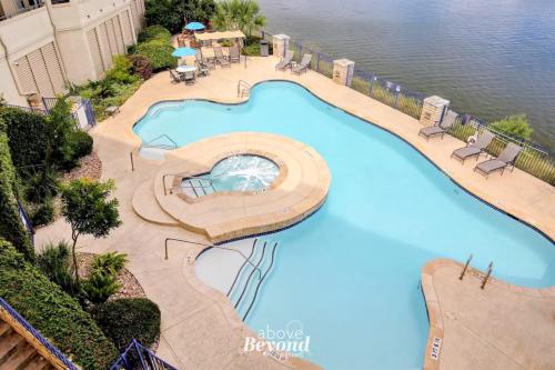 an overhead view of a swimming pool at a resort at Pets Stay Free, Breezy, Stylish Island Elegance in Lago Vista