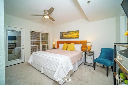 a bedroom with a bed and a blue chair at Color Pop by the Pool in Lago Vista