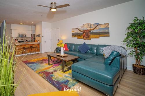 a living room with a blue couch and a table at Color Pop by the Pool in Lago Vista