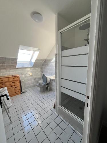 a bathroom with a shower and a toilet at Maison de plage in Guissény