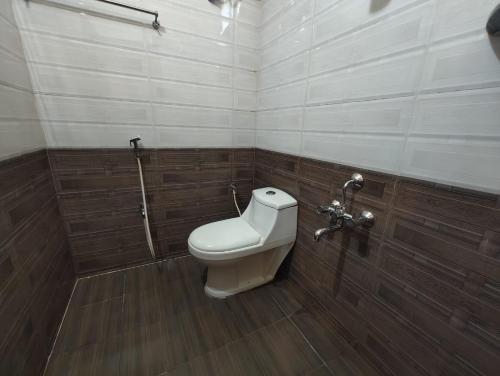 a bathroom with a toilet and a shower at GURU RESIDENCY yercaud in Yercaud