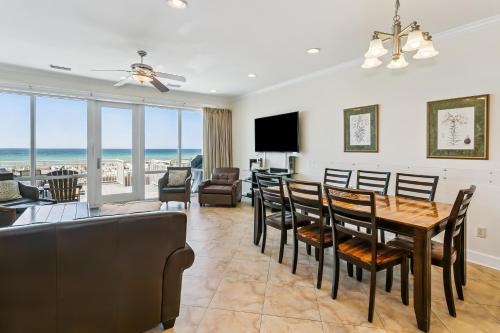 a dining room and living room with a table and chairs at 445 Fort Pickens Rd in Pensacola Beach