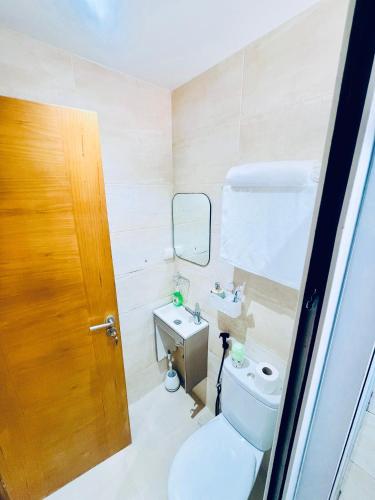 a bathroom with a toilet and a sink at Qlbs sweet room in Abidjan