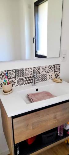 a bathroom with a sink and a mirror at Le Vivastella in Cucq