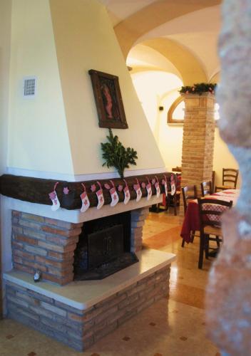 a living room with a brick fireplace with christmas decorations at Agriturismo Cà Nuova in Minerbio