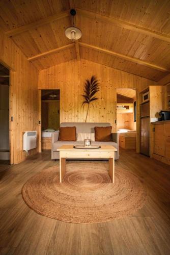 a living room with a couch and a coffee table at Camping 3 étoiles - Piscine - ccbfh0d in Saint-Amand-de-Coly