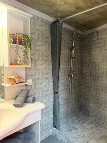 a bathroom with a shower with a shower curtain at La mina's house in Symi