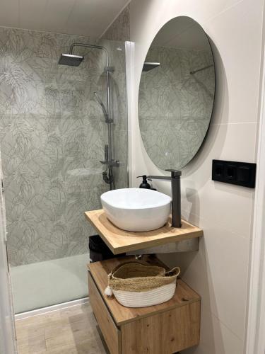 a bathroom with a sink and a mirror at Vcc Home’s in Puerto de Mazarrón