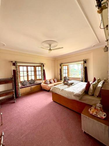 a bedroom with a large bed and a couch at vishwaram Homestay in Chail