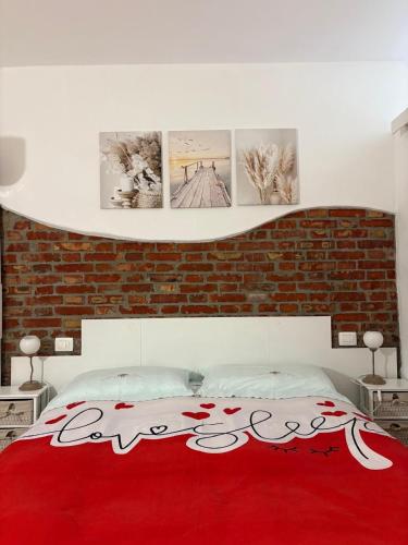 a bedroom with a red blanket on a bed at Maison 24 in Tuscania