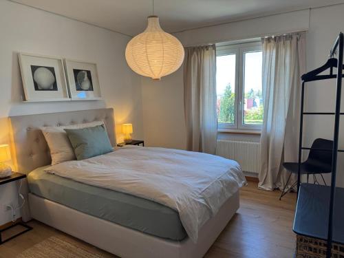 a bedroom with a bed and a large window at inHome Vista Murten in Murten