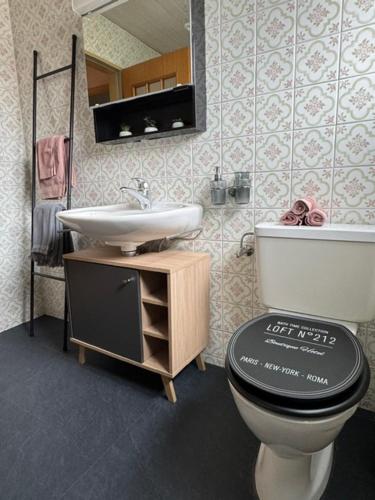 a bathroom with a toilet and a sink at inHome Vista Murten in Murten