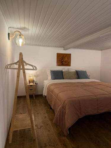 a bedroom with a large bed and a tripod at La mina's house in Symi