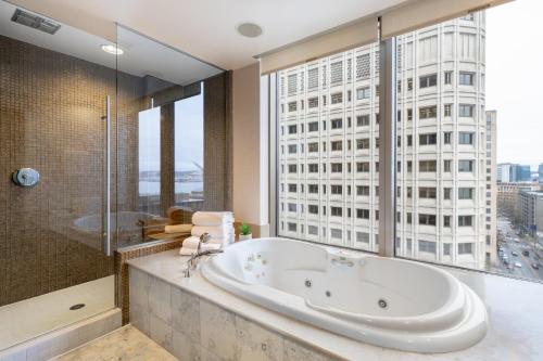 a bathroom with a tub and a large window at Hotel 1000, In The Unbound Collection By Hyatt in Seattle