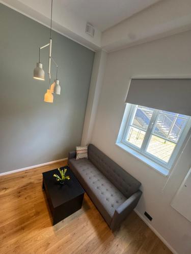 a living room with a couch and a window at Lossipargi Loft in Haapsalu