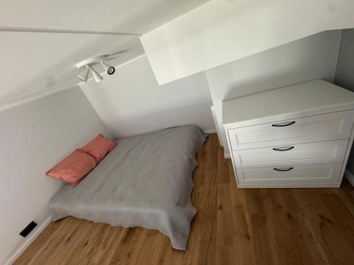 a small bedroom with a bed and a dresser at Lossipargi Loft in Haapsalu