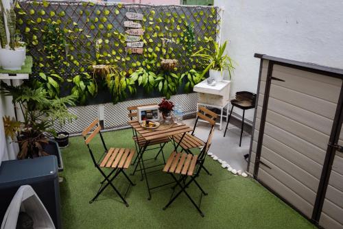 a patio with a table and chairs on a balcony at Live Puertito Neptune Beach in Puertito de Güímar