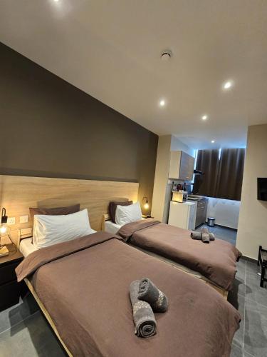 a hotel room with two beds with towels on them at Mingles Suites in Il-Gżira