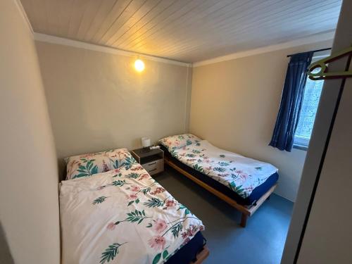 a small room with two beds and a window at La Pergola in Avegno