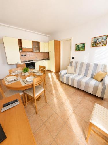 a living room with a couch and a table at PETRONIA TRILO VISTA MARE - Agenzia Cocal in Caorle