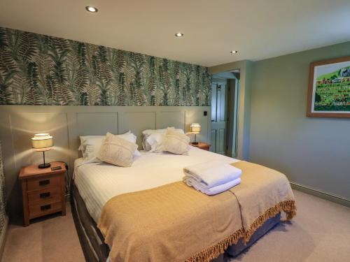 a bedroom with a bed with towels on it at Fogga Croft in Skipton