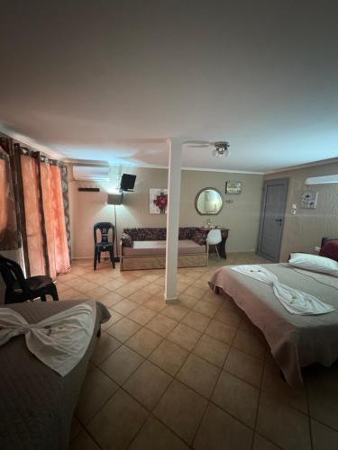 a hotel room with two beds and a couch at Dora sarti in Sarti